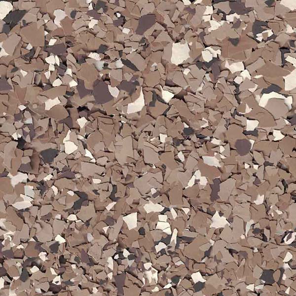 A close-up of a textured surface featuring a mix of brown, beige, and gray flakes, resembling a camouflage pattern, with no landmarks visible.